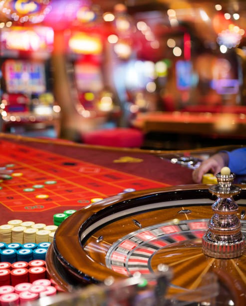 Live casino dealer at blackjack table with multi-camera angle